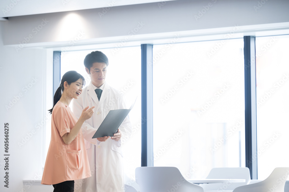 Nurses and doctors discussing medical treatment in a clinic like a hospital, wide angle Nurses and doctors discussing medical treatment in a clinic like a hospital, wide angle