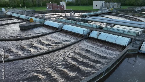 Water running through purification process at sewage treatment plant in USA. Aerial establishing shot at dusk. photo