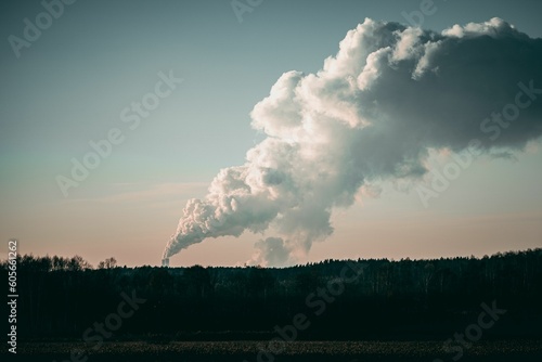 Beautiful shot of smoke coming out of industrial chimneys on a rural valley