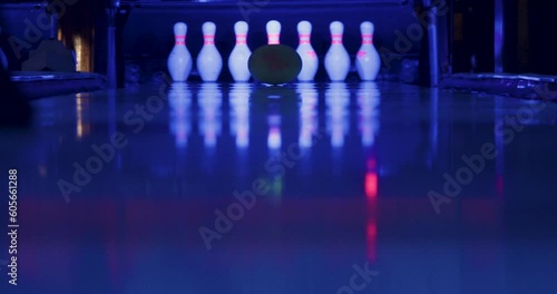 The bowler confidently throws the ball, striking a perfect strike.All ten pins go flying in different directions, leaving a clean slate behind—a triumphant strike for the skilled bowler.