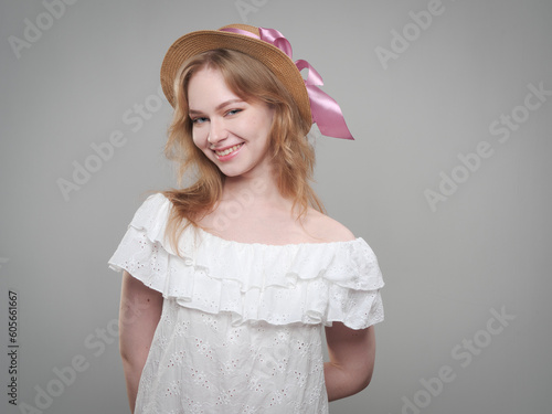 portrait of a beautiful girl with blue eyes on a gray background in the studio