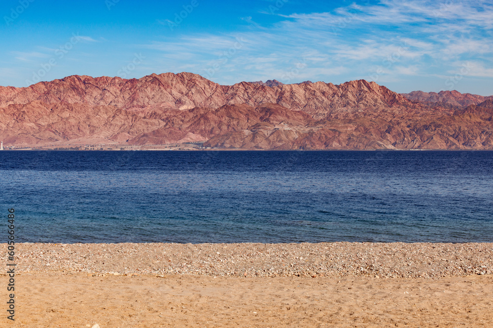 Landscape with layers of water, sand, mountains, and sky the red sea, Eilat Israel Landscape with layers of water, sand, mountains, and sky the red sea, Eilat Israel