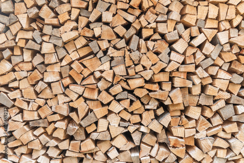 Firewood stack background of woodpile pattern cut from tree wood log with natural texture for fireplace fagot in winter