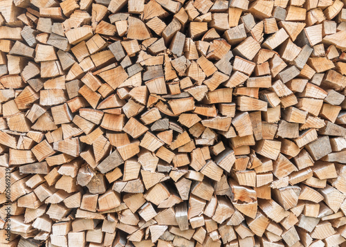 Firewood stack background of woodpile pattern cut from tree wood log with natural texture for fireplace fagot in winter