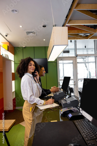 Team of receptionists working at the hotel reception desk photo