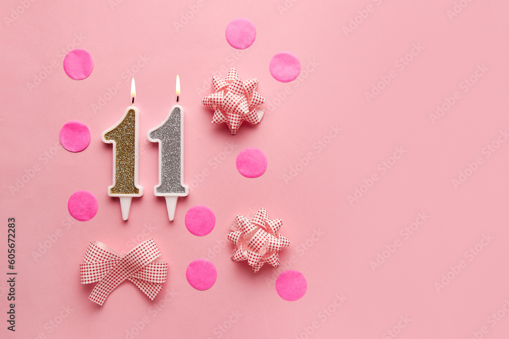 Number 11 on pastel pink background with festive decor. Happy birthday candles. The concept of celebrating a birthday, anniversary, important date, holiday. Copy space. Banner Number 11 on pastel pink background with festive decor. Happy birthday candles. The concept of celebrating a birthday, anniversary, important date, holiday. Copy space. Banner