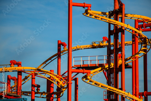 Close up of a roller coaster in amusement park Prater, Vienna with blue sky in the background