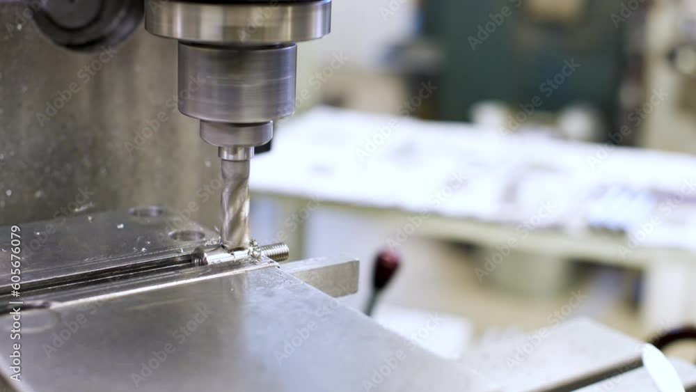 CNC milling machine for cutting stainless steel metal workpiece. Close-up of a cutter in action CNC milling machine for cutting stainless steel metal workpiece. Close-up of a cutter in action