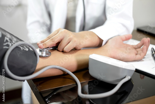 The female doctor measured blood pressure, the patient examined the heartbeat and sat down to talk about health care closely. health care concept