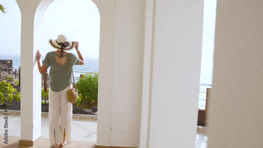 Reveal stylish female traveller arriving Mediterranean Spa hotel Reveal stylish female traveller arriving Mediterranean Spa hotel