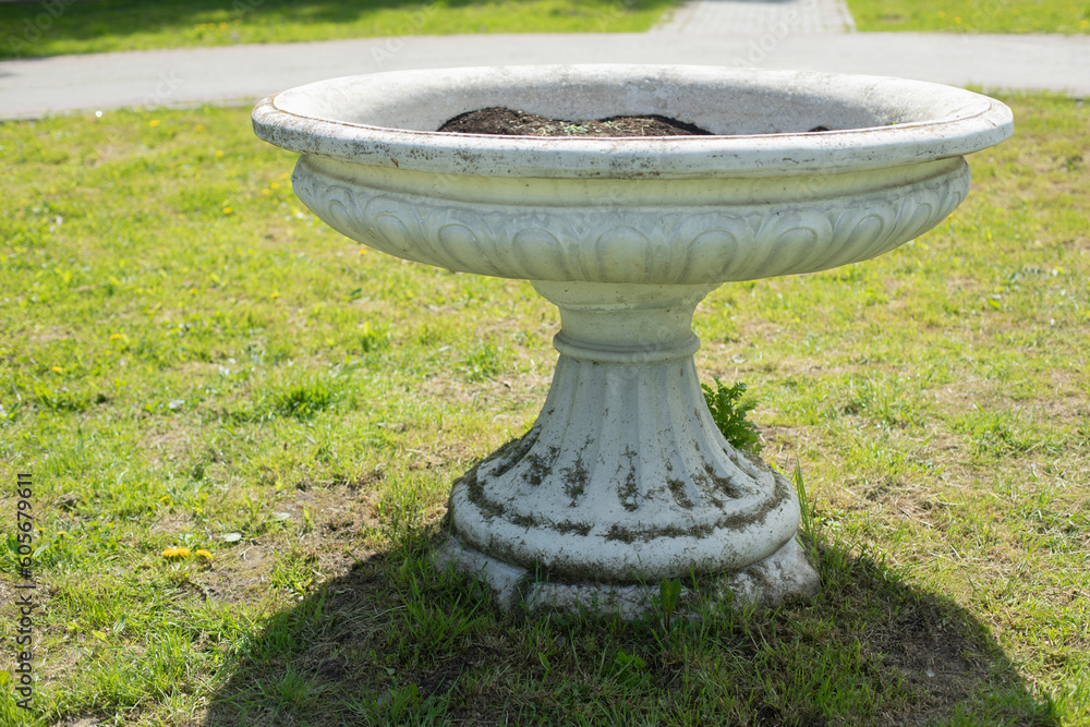 Vase in park. Park architecture of 19th century. Stone flower bed. Vase in park. Park architecture of 19th century. Stone flower bed.