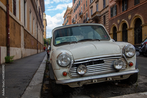 A white old vintage car with round headlights on the bumper © almostfuture