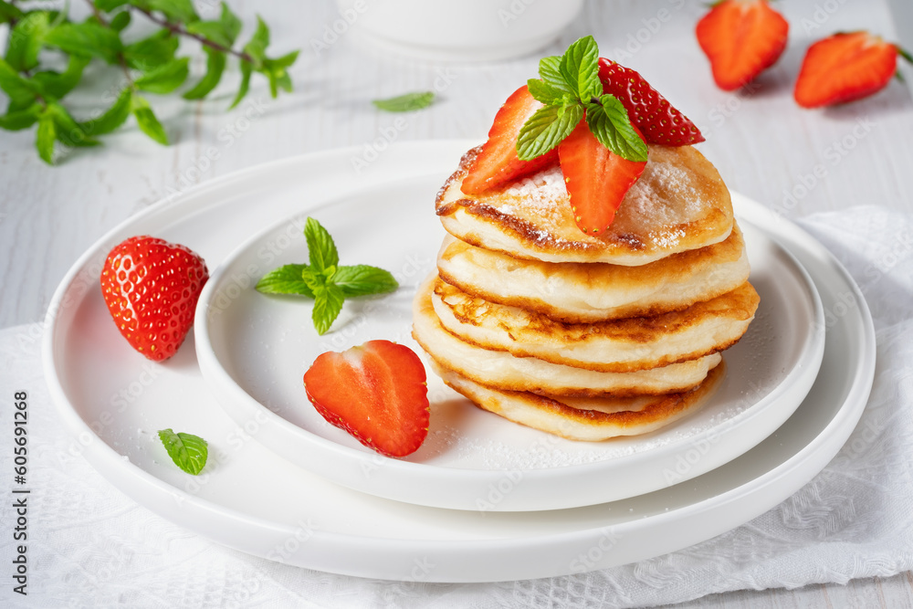 Yummy and fresh mini pancakes with strawberry for summer breakfast Yummy and fresh mini pancakes with strawberry for summer breakfast