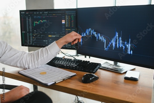 Businessman hand analysing financial stock market graph on board. Trading data index investment growth chart. Cryptocurrency and Forex Concept.