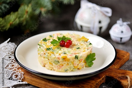 Festive Russian salad with shrimps, canned corn, cucumber, egg, cheese and mayonnaise