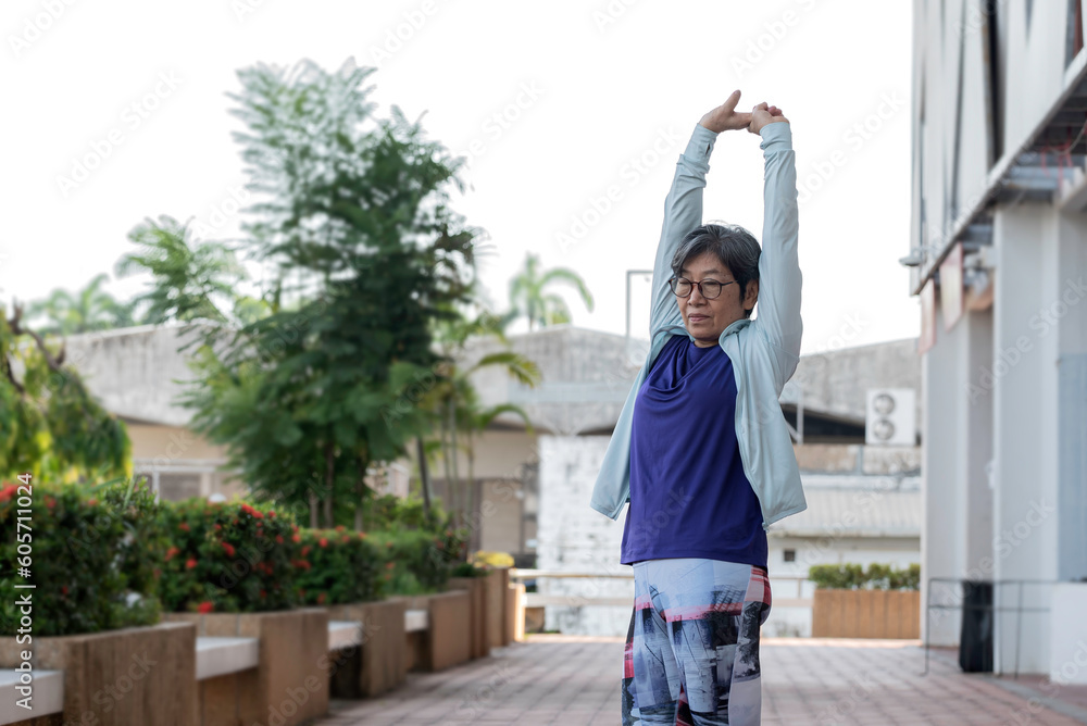 Asian senior women walk exercise outdoor in morning, feel relax and happy in holiday.
