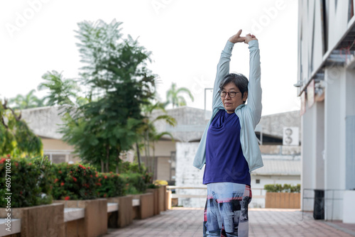 Obraz na płótnie Asian senior women walk exercise outdoor in morning, feel relax and happy in holiday. w salonie