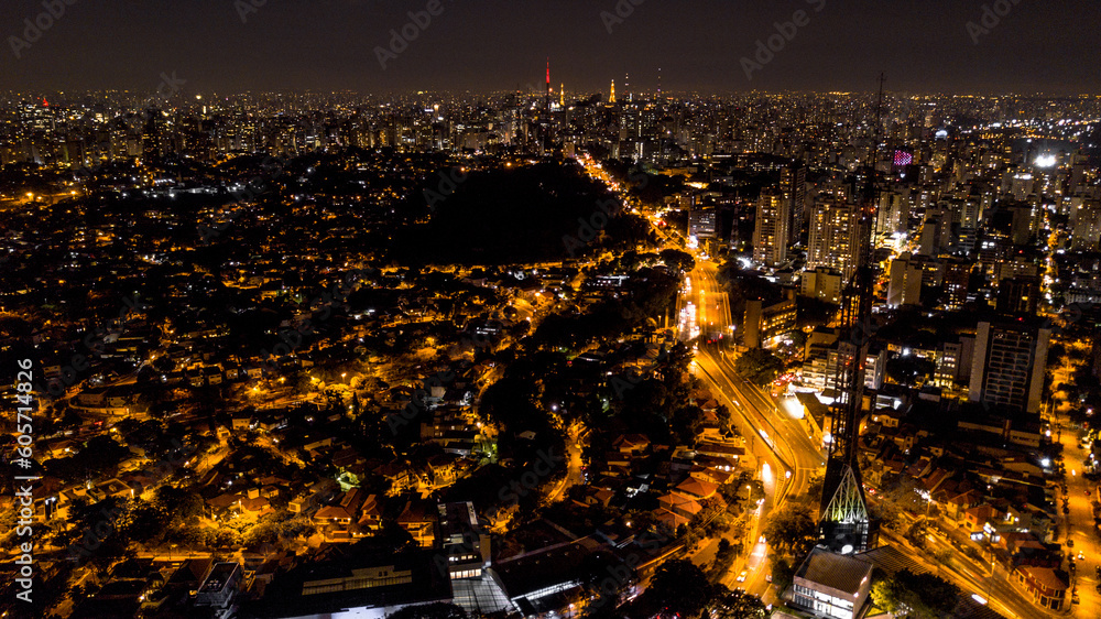 Naklejka premium view from above the city of São Paulo at night, city lights, buildings and houses lit, Brazil