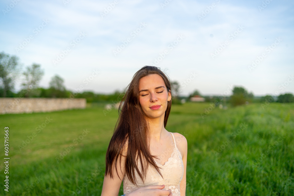 Beautiful Young Happy Woman Enjoying the Sunlight in a Public Park Beautiful Young Happy Woman Enjoying the Sunlight in a Public Park