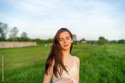 Beautiful Young Happy Woman Enjoying the Sunlight in a Public Park