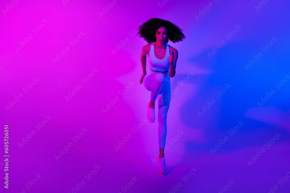 Full length photo of running marathon athlete sportswoman serious face advert clothes for gym isolated on neon colorful filter background Full length photo of running marathon athlete sportswoman serious face advert clothes for gym isolated on neon colorful filter background