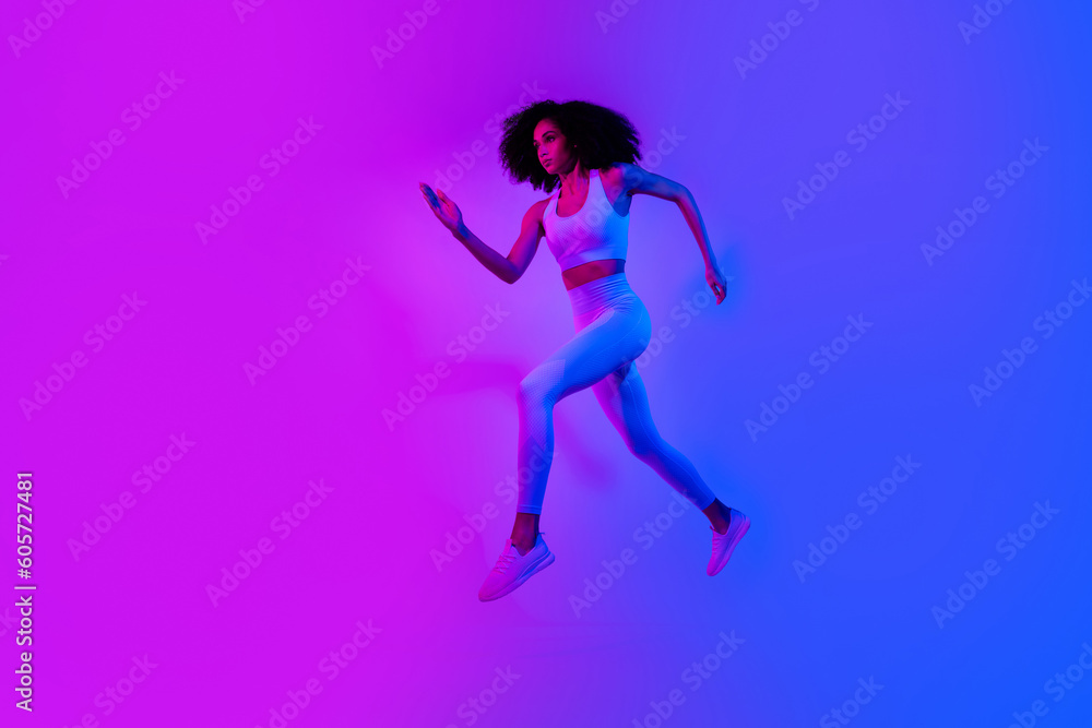 Full size profile photo of beautiful slim girl jump rush empty space ad promo leggings top shoes isolated on neon ultraviolet color background