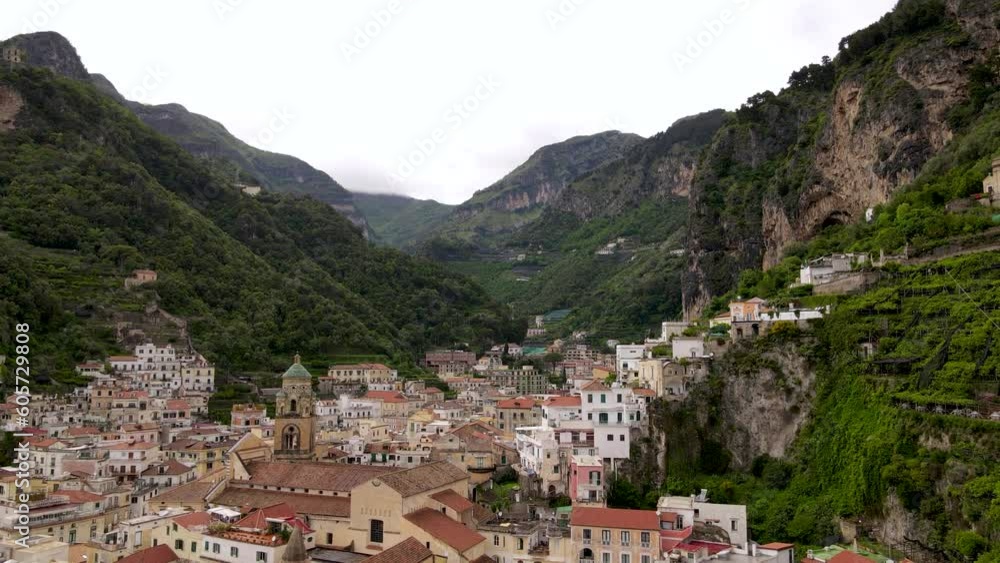 Aerial drone view of old town of Amalfi and mountains, beautiful travel resort Aerial drone view of old town of Amalfi and mountains, beautiful travel resort