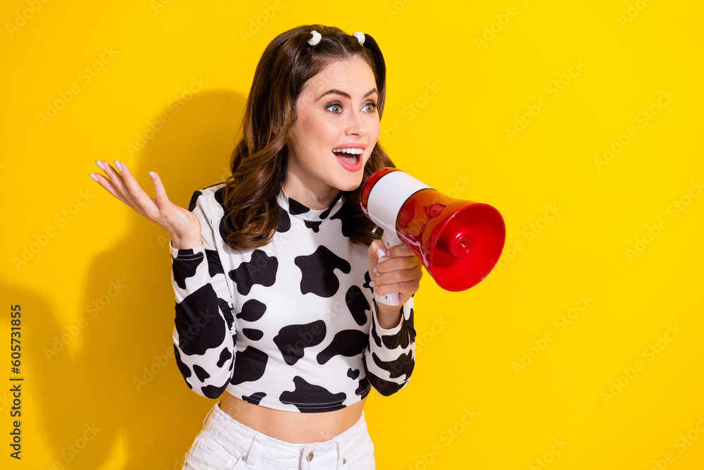 Photo of youth funny girl hold bullhorn scream loud announcement big sale starts wear cowskin crop top isolated on yellow color background Photo of youth funny girl hold bullhorn scream loud announcement big sale starts wear cowskin crop top isolated on yellow color background
