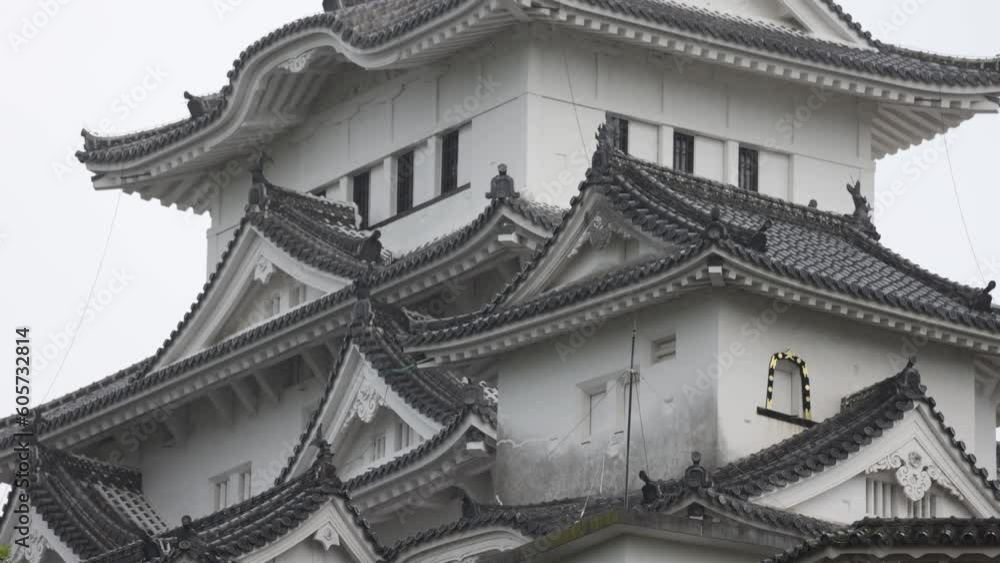 Tilt up on historic Japanese castle in Himeji on grey overcast day Tilt up on historic Japanese castle in Himeji on grey overcast day