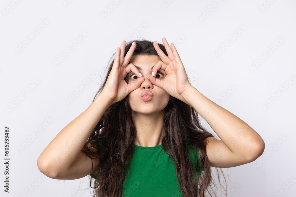 Smiling girl gesturing OK sign with her hand Smiling girl gesturing OK sign with her hand