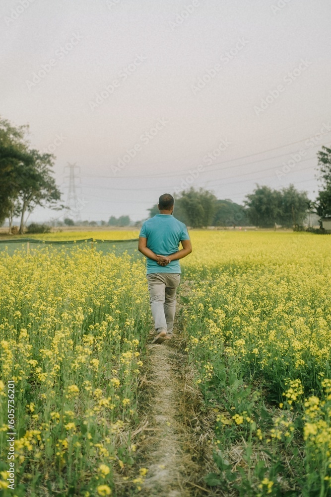 person watering a field