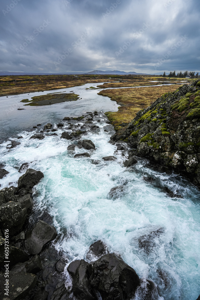 Beautiful landscape of Iceland. Landmark photo with an amazing waterfall from Thingvellir National Park of Iceland.