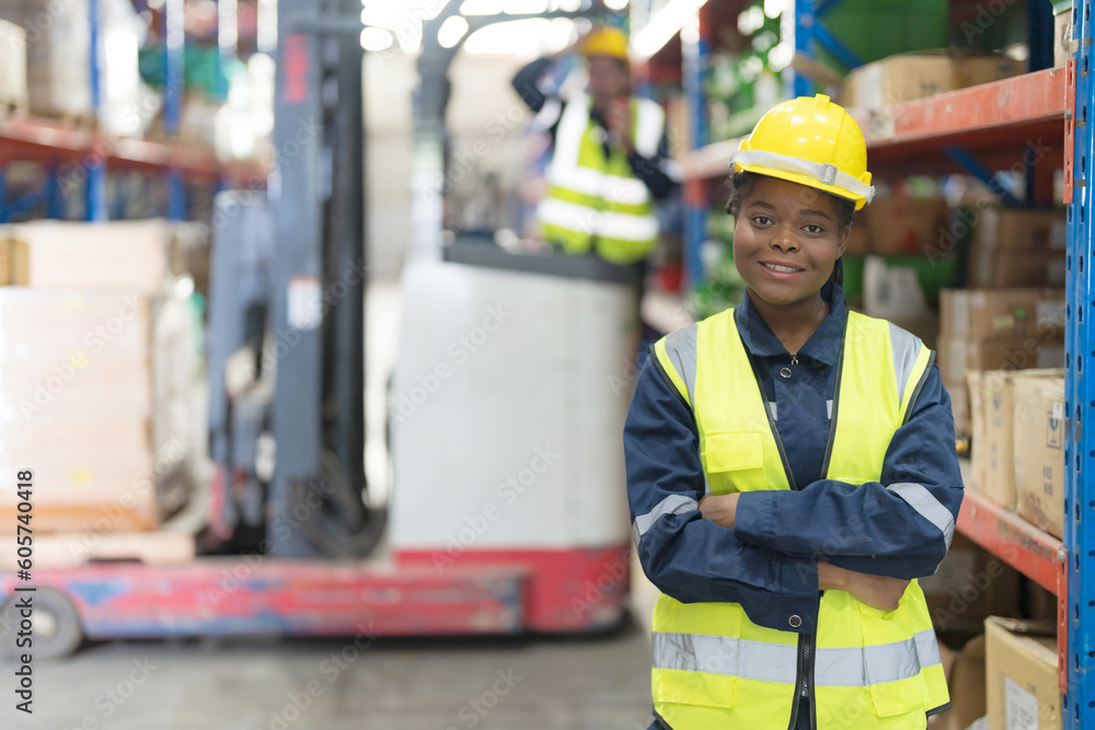 A female worker stands in a factory or warehouse. A female worker stands in a factory or warehouse.