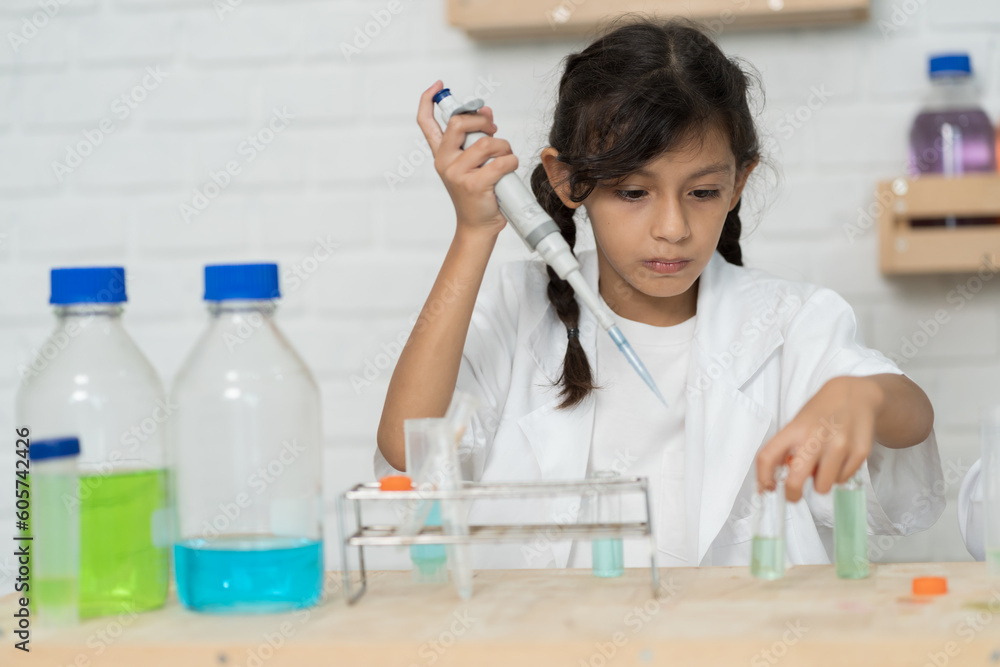 Child girl learning science and analyse liquid in the laboratory at school. Science and education, researcher and discovery concept Child girl learning science and analyse liquid in the laboratory at school. Science and education, researcher and discovery concept
