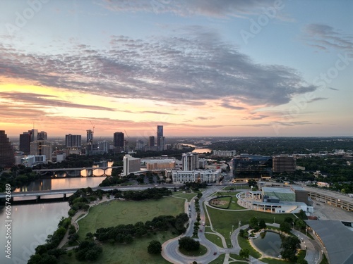 Downtown Austin Texas during early morning sunrise with orange red clouds in the horizon. 