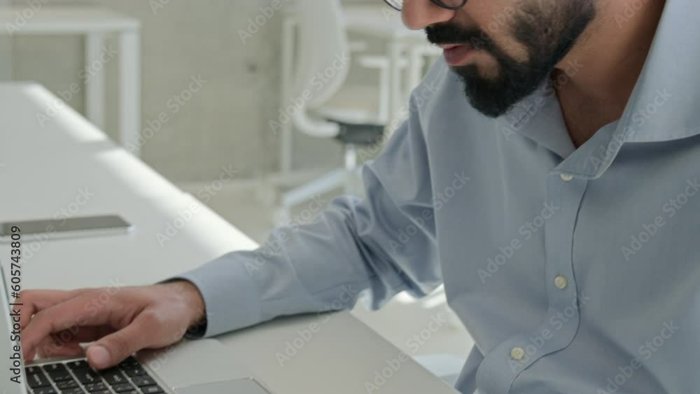 Thoughtful Arabian Indian man muslim male businessman entrepreneur lawyer professional executive manager working laptop check information count budget read business contract legal documents paperwork Thoughtful Arabian Indian man muslim male businessman entrepreneur lawyer professional executive manager working laptop check information count budget read business contract legal documents paperwork