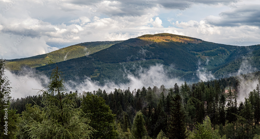 Mountain landscape with cloudy sky and steaming forest. Mountain landscape with cloudy sky and steaming forest.