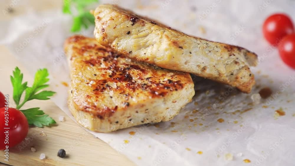 Pieces of fried meat on a cutting board. Close-up. Slow motion. High quality FullHD footage Pieces of fried meat on a cutting board. Close-up. Slow motion. High quality FullHD footage