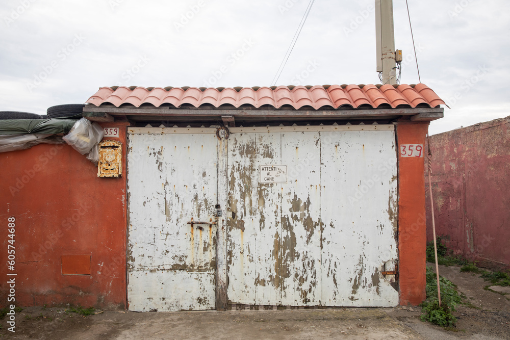 Front view of a peeling white gate with a 