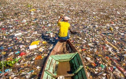 People collect trash that can be recycled and traded from the sea of garbage in the Citarum River, the one of polluted river in Bandung, West Java, Indonesia
