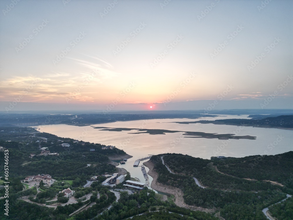 Aerial view of Lake Travis and the Texas Hill Country during a passing thunderstorm at sunset.