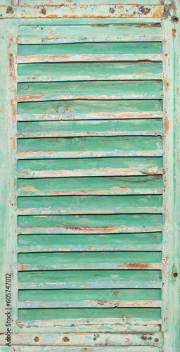 Texture and background of an old wooden shutter with horizontal slats.