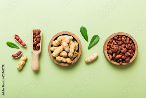 Fresh healthy peanuts in bowl on colored table background. Top view Healthy eating bertholletia concept. Super foods