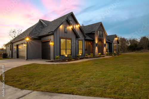 Exterior Modern Farmhouse at Dusk with Pink and Blue Sky From an Angle