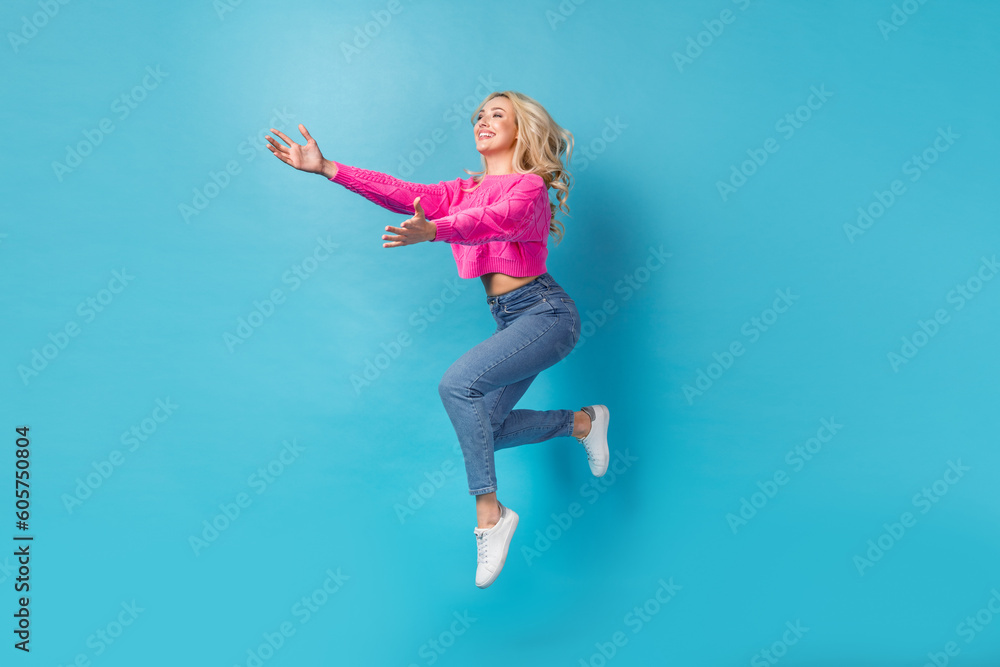Full length size photo of attractive girl wear stylish garment jumping want hugs with new friends isolated on blue color background Full length size photo of attractive girl wear stylish garment jumping want hugs with new friends isolated on blue color background