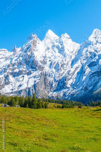 Amazing tourquise Oeschinnensee with waterfalls and Swiss Alps, Kandersteg, Berner Oberland, Switzerland.