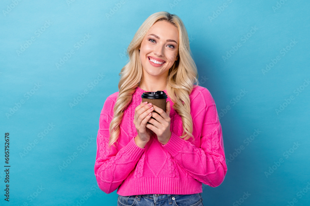 © deagreez - Portrait of optimistic cute girlish woman with curly hairstyle wear knit pullover hold cup of coffee isolated on blue color background © deagreez - Portrait of optimistic cute girlish woman with curly hairstyle wear knit pullover hold cup of coffee isolated on blue color background