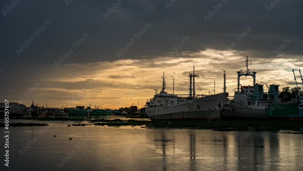 Time lapse Water hyacinth flows along the Mae Kong River. Sunset after rain beautiful golden sky. Time lapse Water hyacinth flows along the Mae Kong River. Sunset after rain beautiful golden sky.