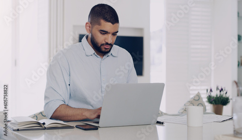 Man, remote work and typing at laptop in home for digital planning, online research and information at table. Male freelancer working on computer technology, internet and reading email for budget