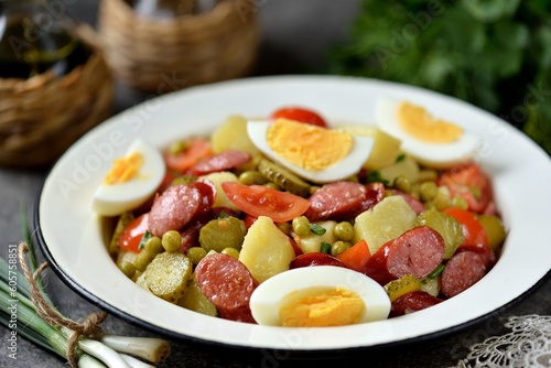 Salad of potatoes, pickled cucumbers, red onions, smoked sausages, tomatoes and boiled eggs.